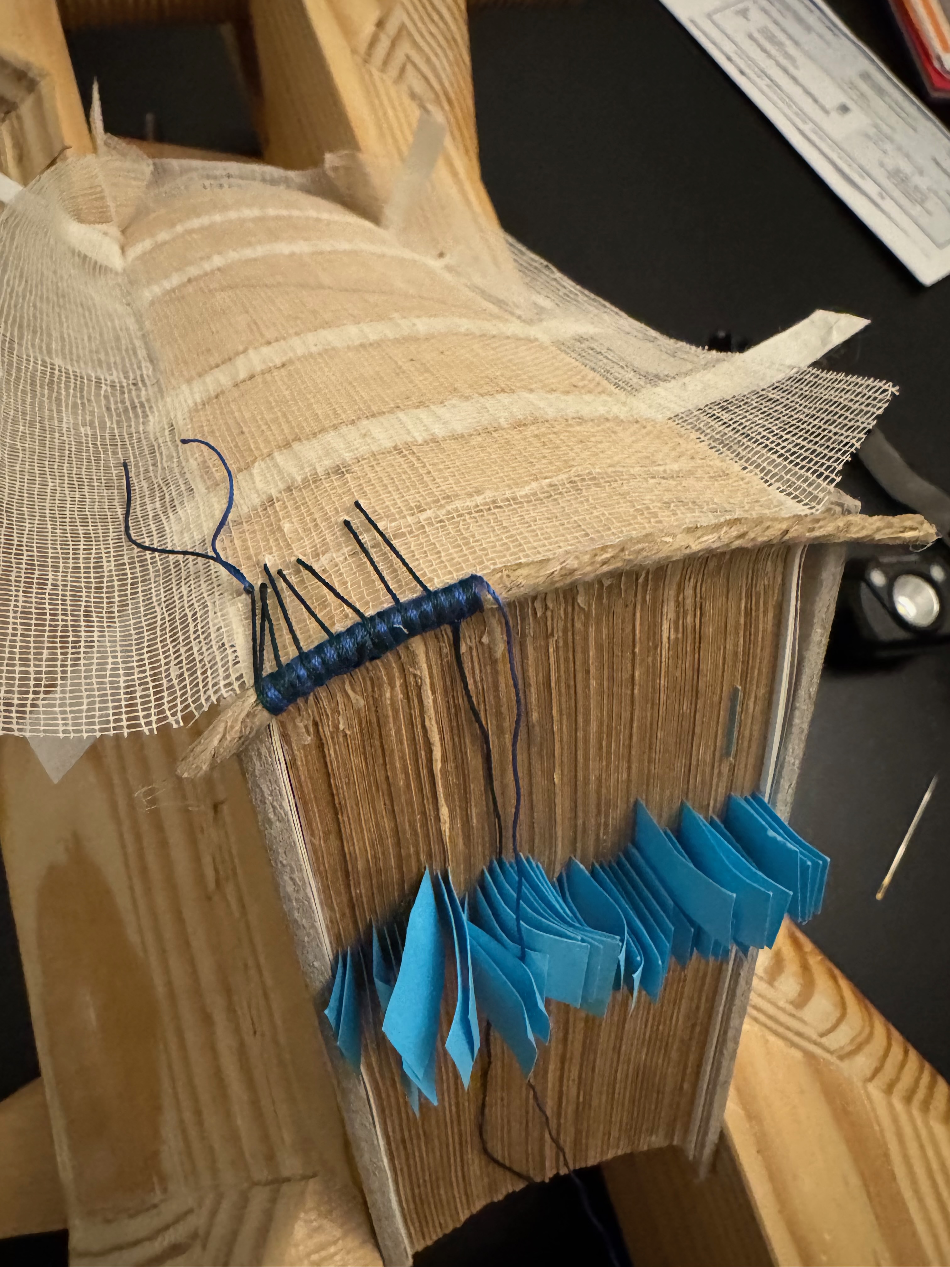 Checking that the threads are coming out beyond the kettle stitch