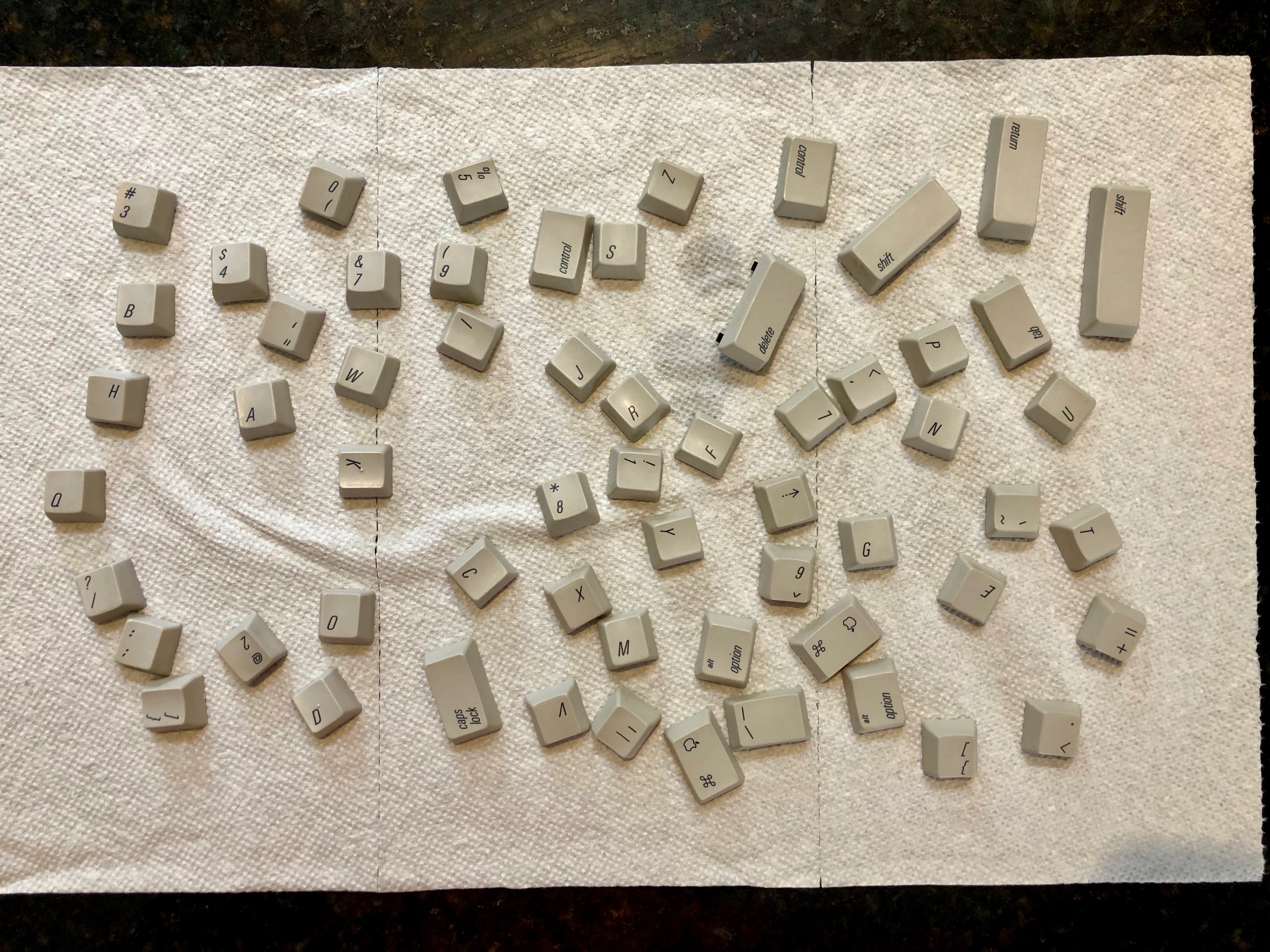'Clean keycaps drying on a paper towel'